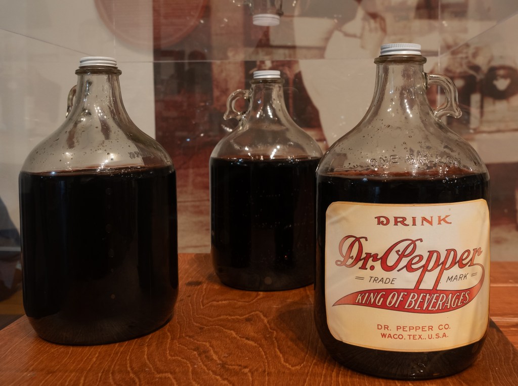 Vintage bottles of Dr. Piper exposed in Dr. Pepper Museum in Waco, Texas with a labeled bottle